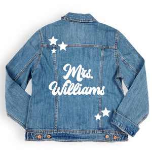 A jacket lays out and says "Mrs. Williams" in white with some stars around it.