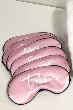 Light Pink sleep masks are placed together with customized script names.