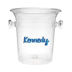 A clear ice bucket with "Kennedy" on the front in blue cursive