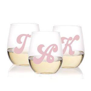 Three wine glasses are customized with a retro initial in light pink.