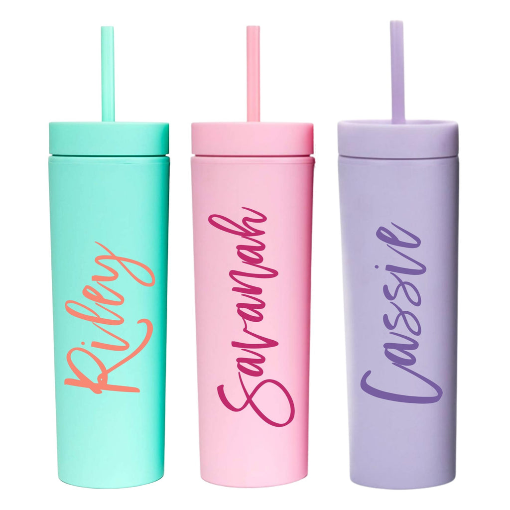 Three matte tumblers in green, pink, and purple customized with a cursive font