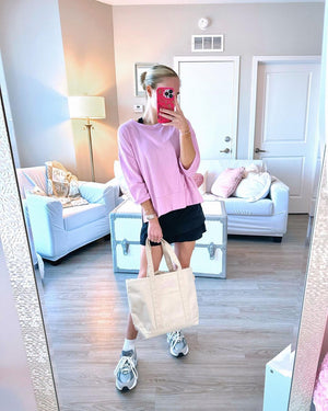 A blonde takes a mirror selfie with her personalized canvas tote bag
