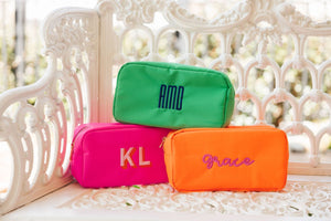 Bright colored embroidered pouches customized with names and monograms