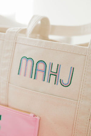 A canvas tote with the word "Mahj" embroidered on the front