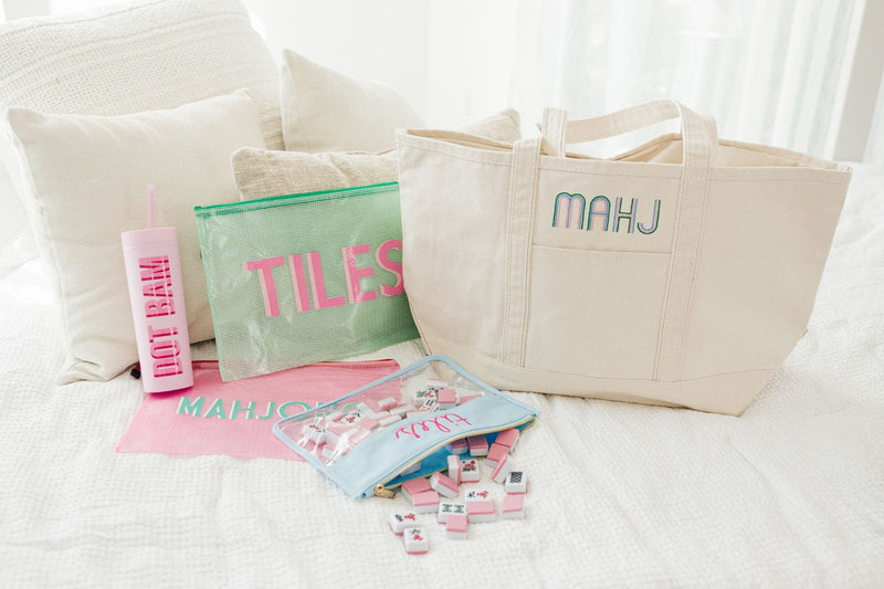 An array of custom Mahjong products sits on a bed