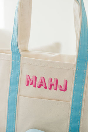 A canvas tote with the word "Mahj" embroidered on the front