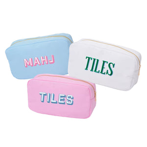 Three large, embroidered Mahjong inspired pouches in blue, white, and pink