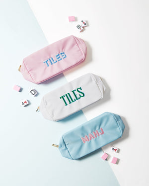 Three embroidered pouches have Mahjong phrases on the front of them