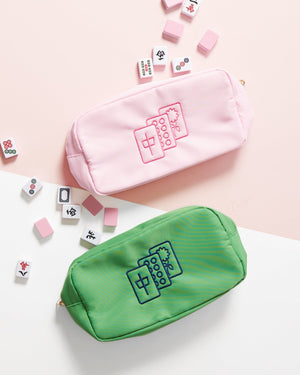 Two pouches one in pink and one in green feature embroidered Mahjong tiles on the front
