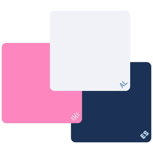 Three monogrammed Mahjong tile mats in white, blue, and pink