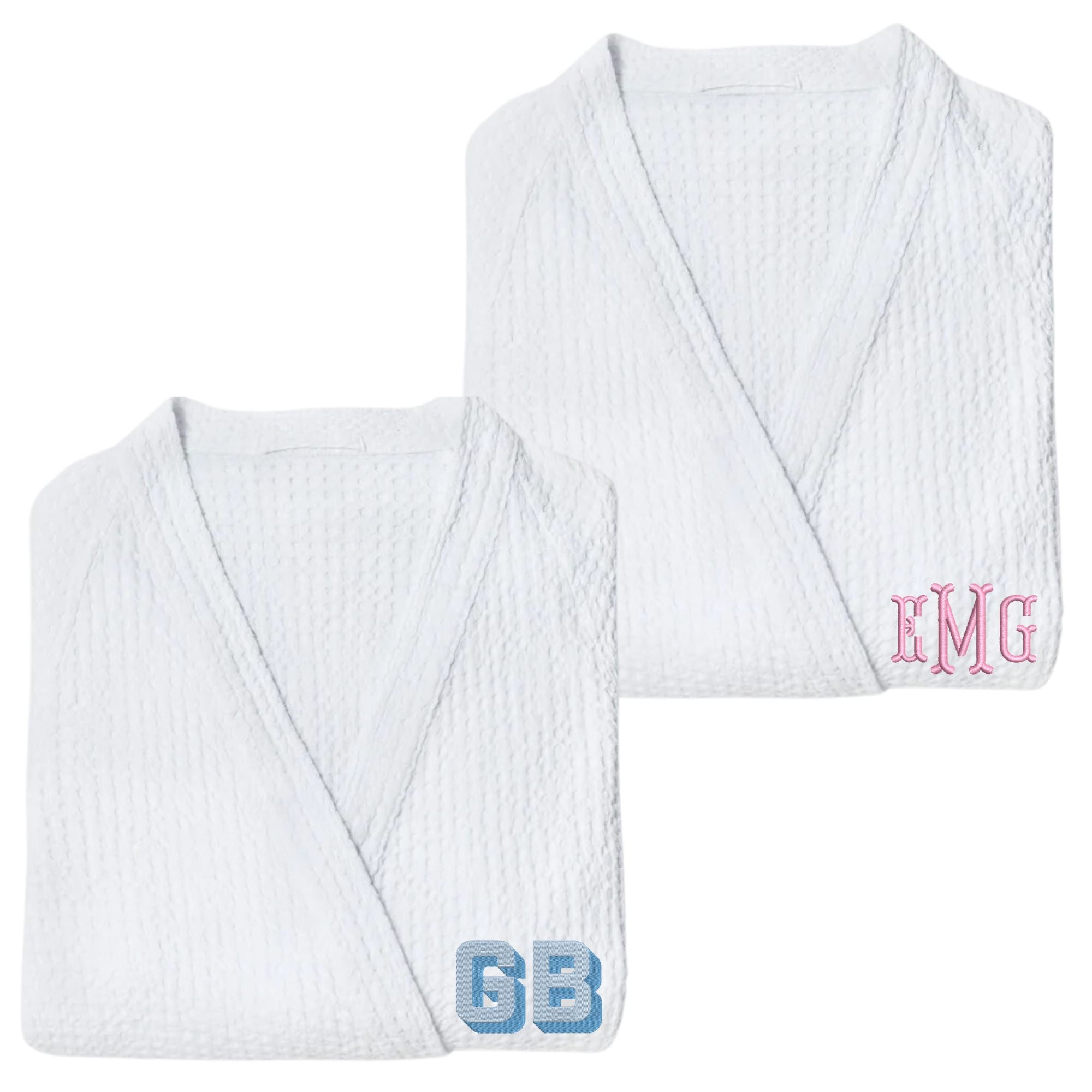 Two robes are embroidered with a pink and a blue monogram.