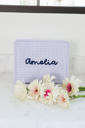 A purple roadie is customized with the name "Amelia" in a script font