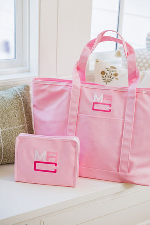 A pink coated canvas and a pink roadie are monogrammed.