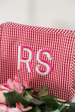A red roadie is customized with a pink and white monogram.