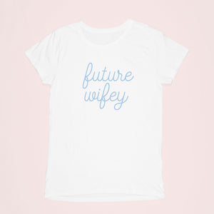 A shirt lays flat and shows off it's blue writing which reads "future wifey"