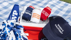 A collection of custom gameday gear sits on a picnic blanket