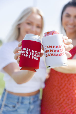 Two women hold out can coolers themed for the big game