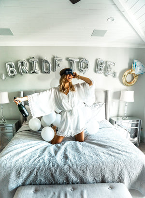 A soon-to-be-bride wakes up in a decorated bedroom while wearing a custom sleep mask