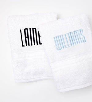 White guest towels with last names embroidered on them