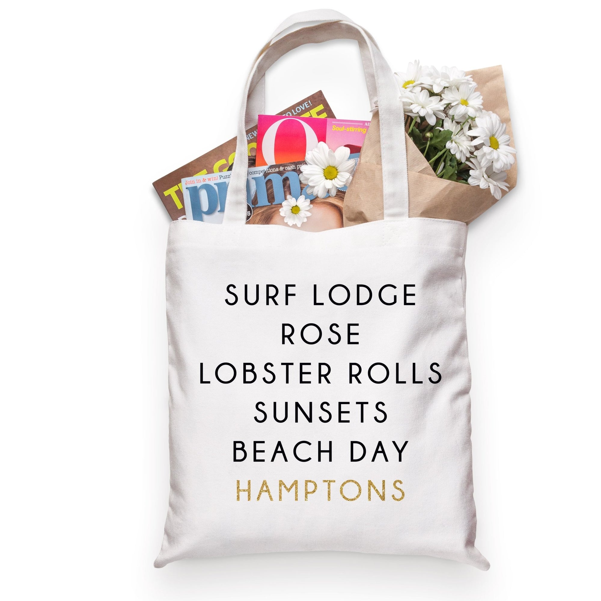 A cotton tote filled with flowers and a magazine is customized to be the perfect tote to take to the Hamptons