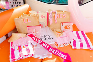 A collection of our custom bachelorette party gifts in an orange and pink theme