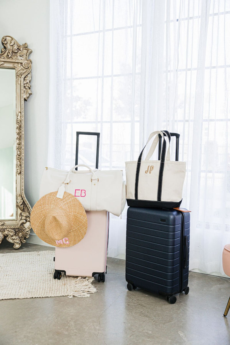 An assortment of personalized travel accessories are placed together. 