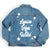 A denim jacket is customized with a design that says "Leave Her Wild" and has stars around it.