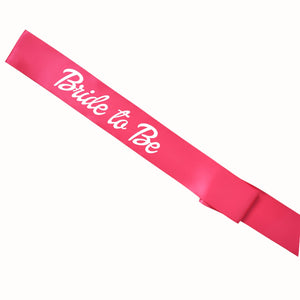 A pink sash reads "Bride To Be" in a doll themed font