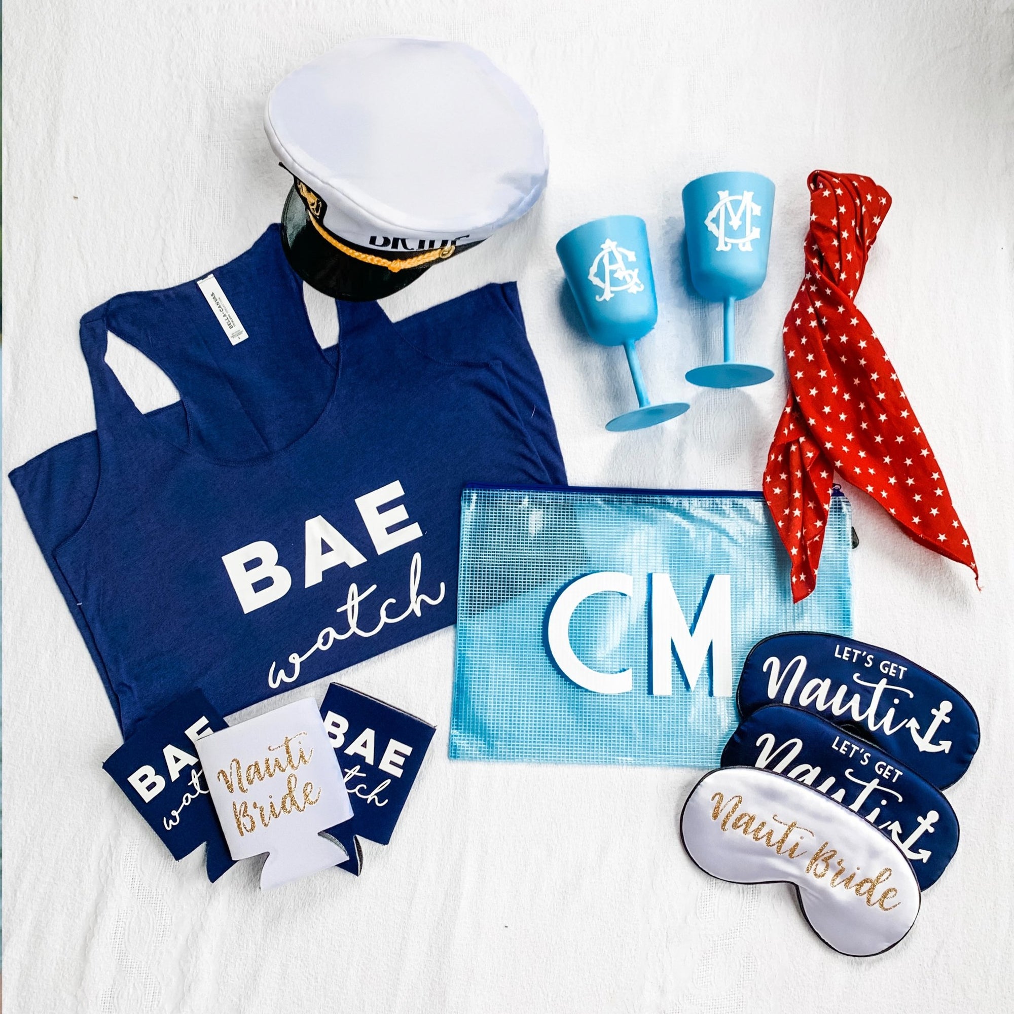 A white sleep mask that reads "Nauti Bride" in gold is paired with two navy sleep masks which read "Let's Get Nauti" in white writting.