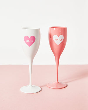 Two acrylic champagne flutes with a heart that reads "Mahj"