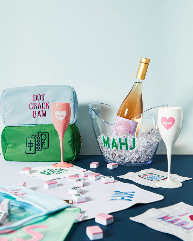 Set of four mahjong-themed cocktail napkins styled with drinks and game accessories