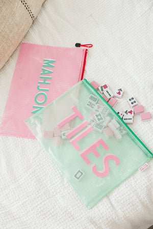 Green and pink Mahjong bags hold tiles