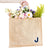 A jute tote with a "J" monogrammed on the bottom corner