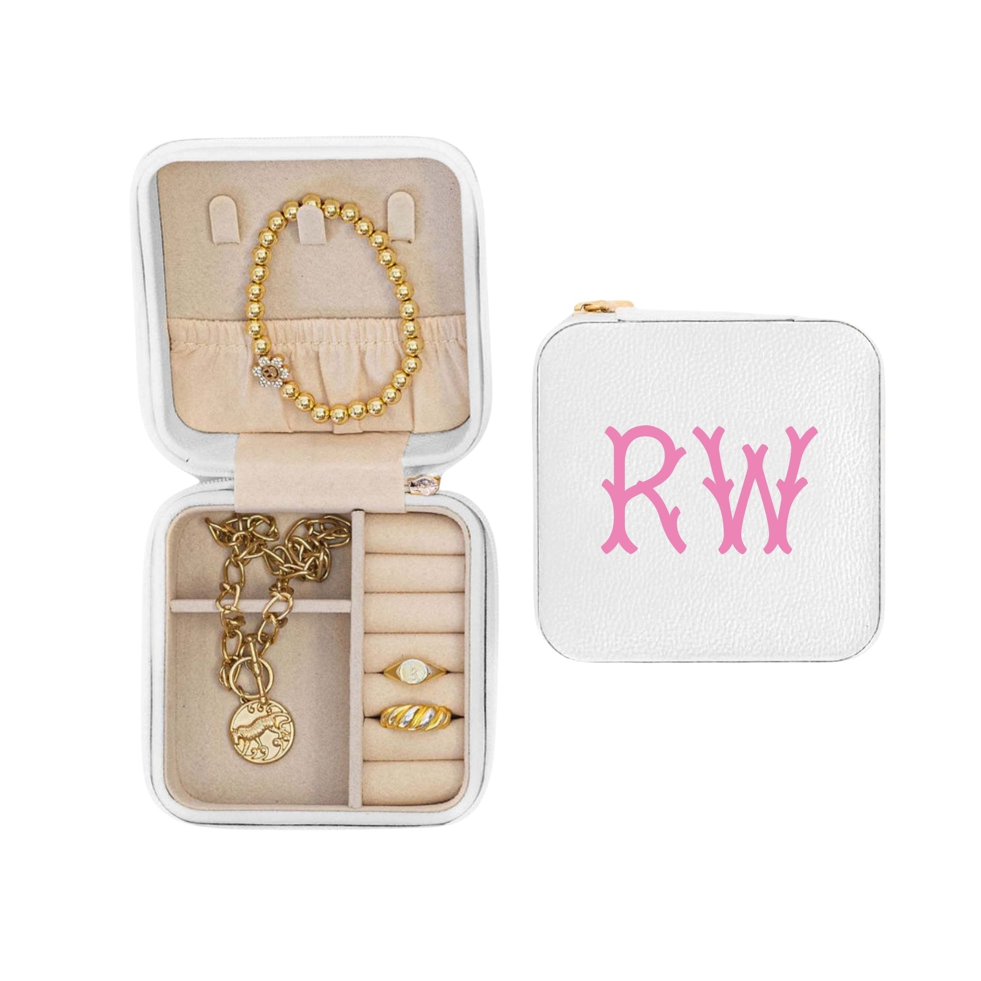 A white monogrammed jewelry case featuring our custom fishtail monogram and showing the storage on the inside.