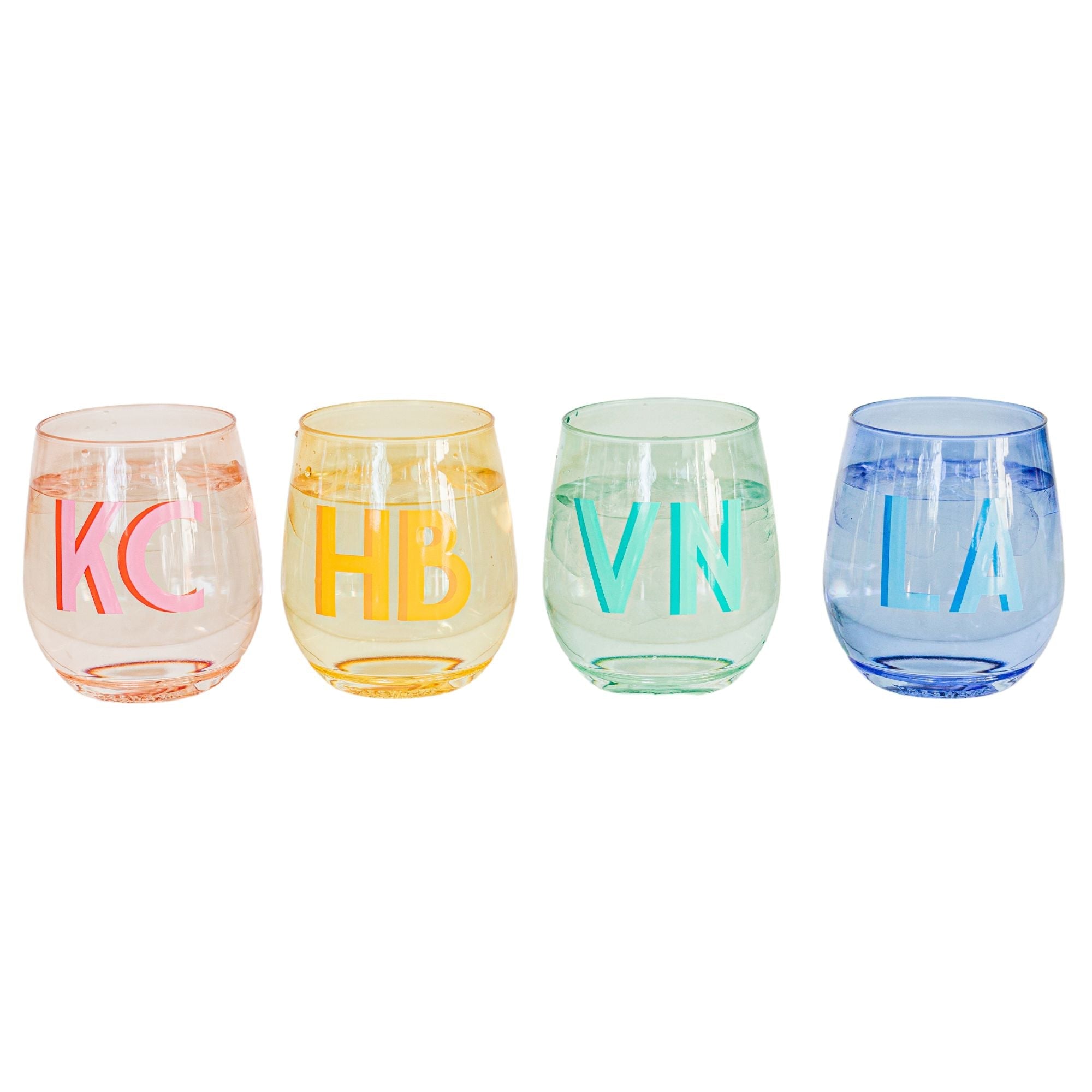A pink, yellow, green, and a blue wine glass are personalized with different colored monograms.