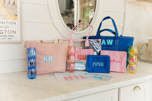 A collection of bags and cups are personalized with names and monograms.