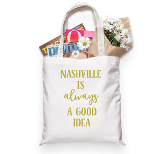 A tote is customized to read "Nashville is always a good idea" in gold font.