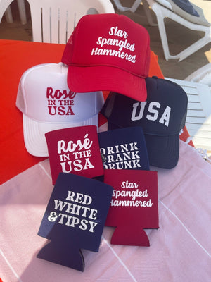 A collection of patriotic koozies and trucker hats
