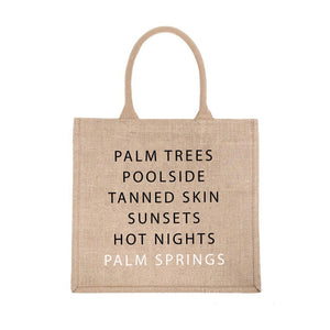 A jute carryall tote customized with sayings about Palm Springs