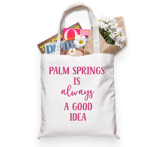 A cotton tote is customized with pink text that reads "Palm Springs is always a good idea".