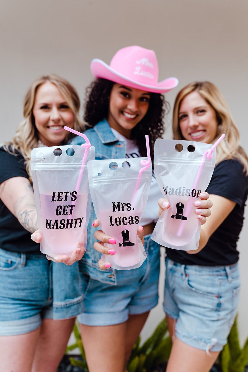 A group of three women celebrate a cowgirl bachelorette
