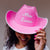 A pink cowboy hat is customized with white font which reads "Mrs. Johnson".