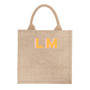 A tote with customized pink and yellow letters