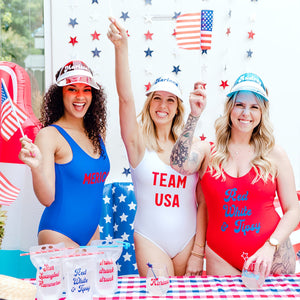 A group of girls in red, white and blue swimsuits celebrate the 4th of July with their custom products.