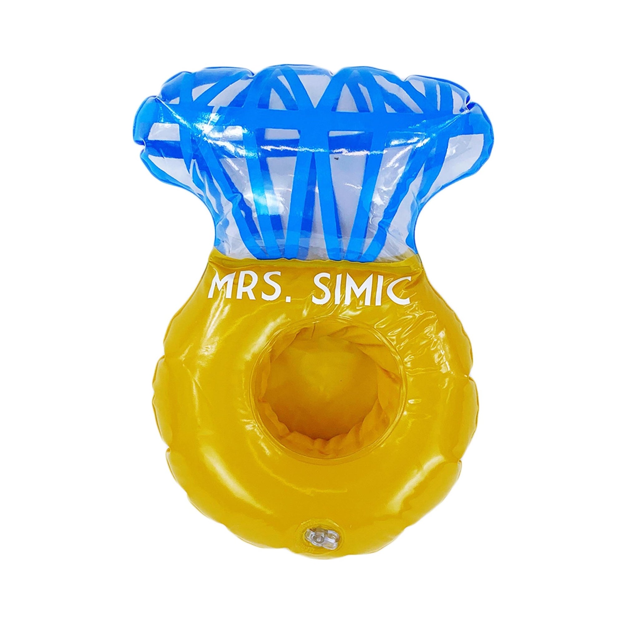 A drink float shaped as a ring is customized with "Mrs. Simic" in white font.