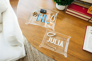 Two acrylic trays are personalized and filled with jewelry and car keys.