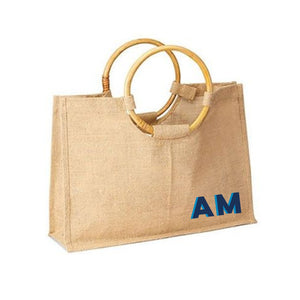 A bamboo jute is customized with a blue monogram on the bottom corner