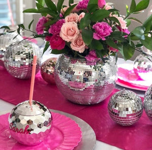Our disco ball tumblers sit on a table with other disco-themed decorations