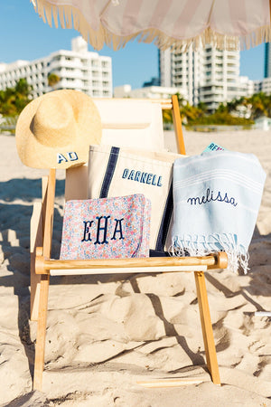 An assortment of personalized accessories sitting on a beach chair