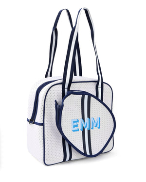 A monogrammed pickleball bag with blue lettering